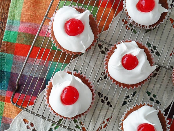 An overhead photo of cherry cupcakes on a cooling rack.