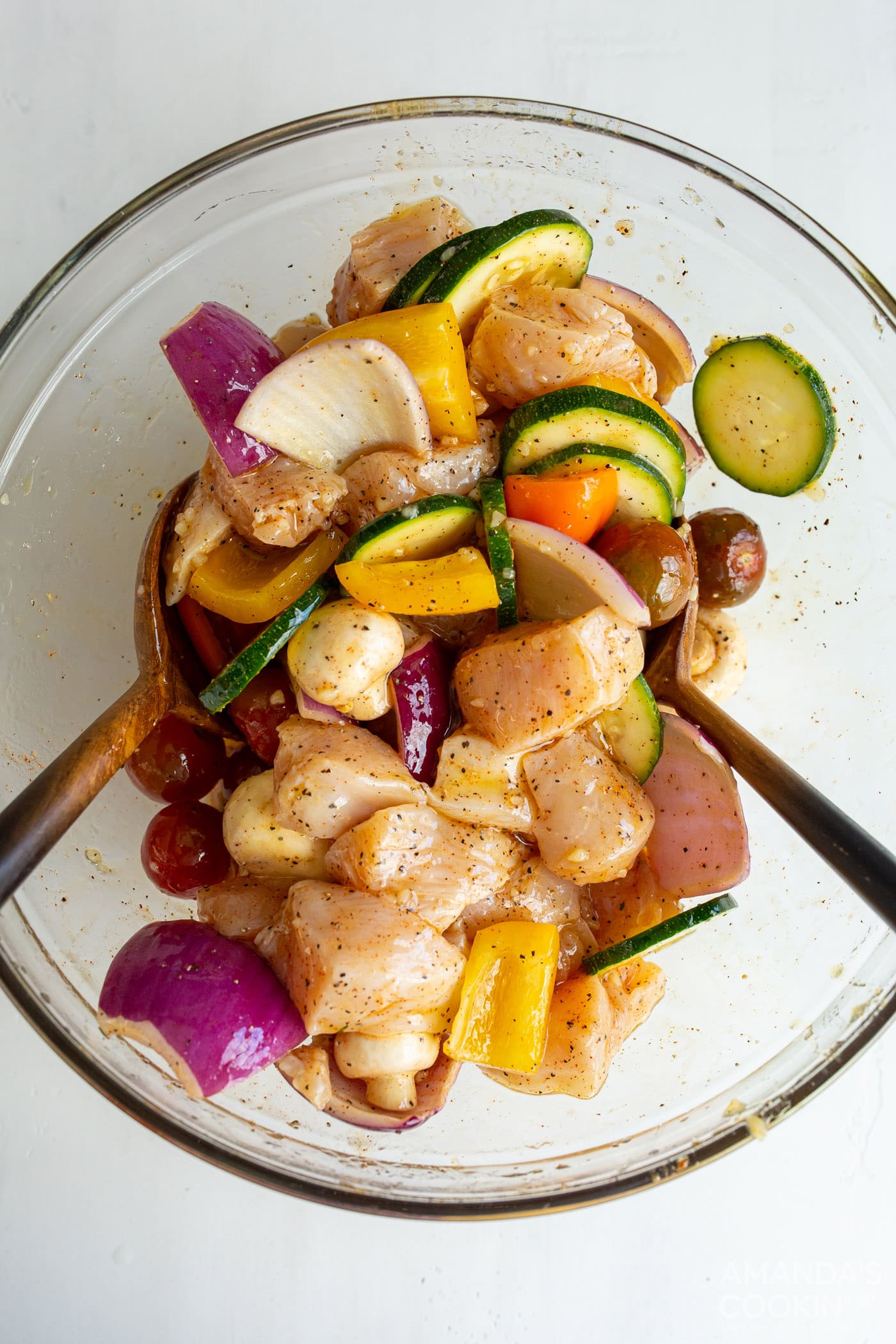 chicken and veggies in a bowl with marinade