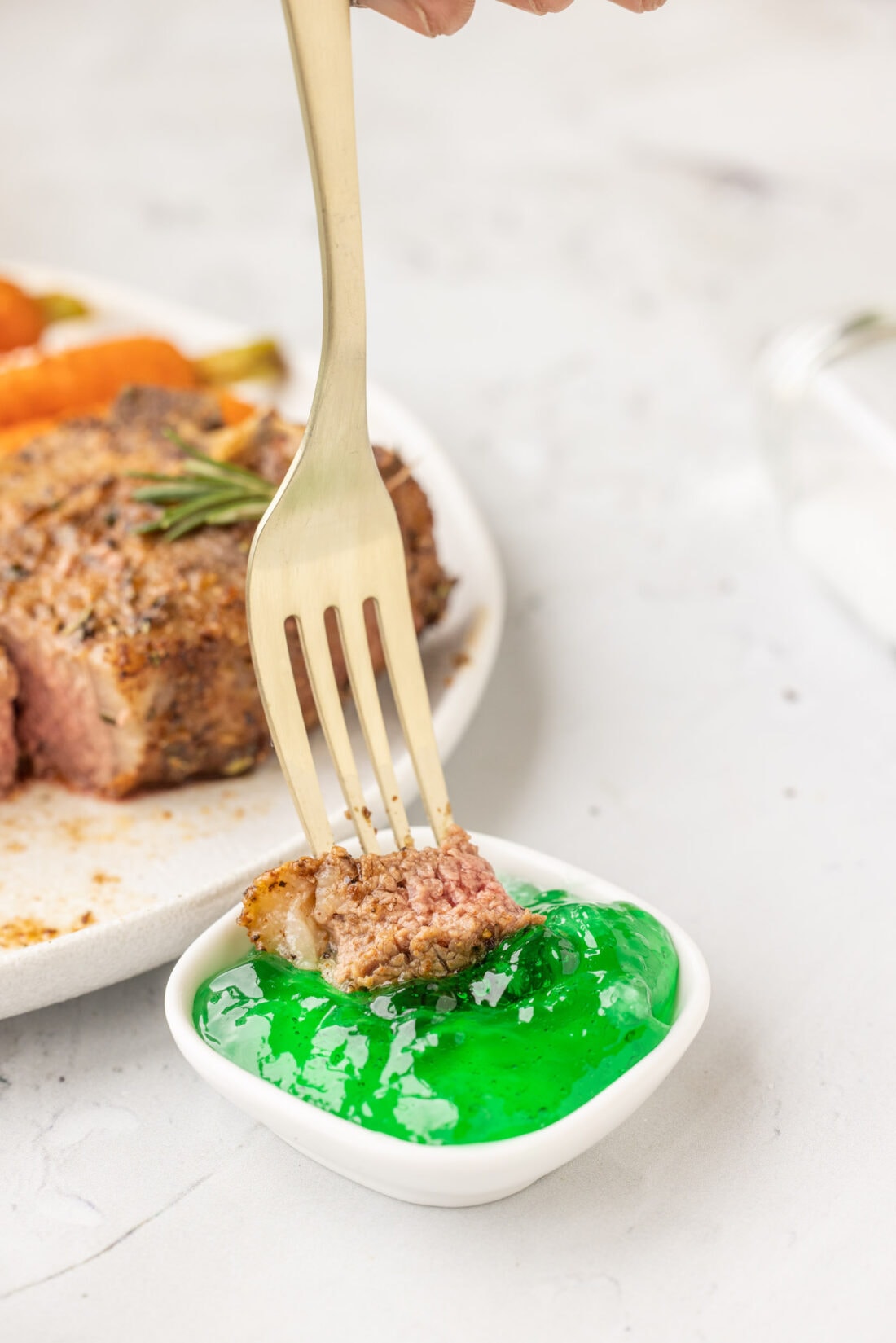 dipping Air Fryer Lamb Chop in mint jelly