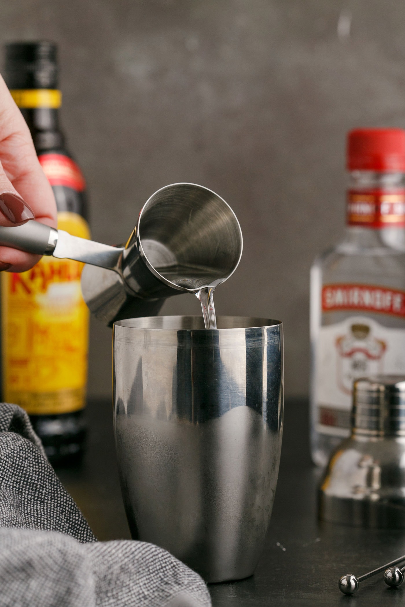 pouring vodka into cocktail shaker