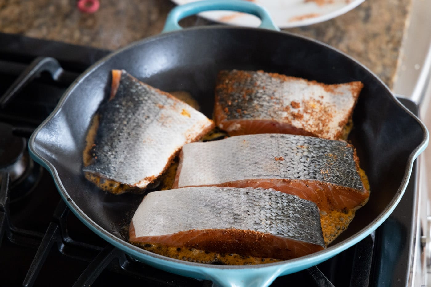 cooking salmon skin side up in a skillet