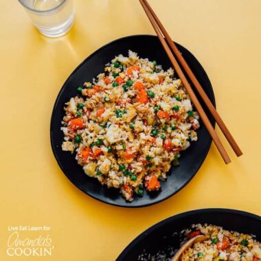 black bowl with cauliflower fried rice and chop sticks