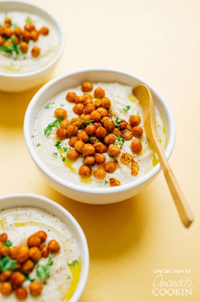 Crockpot creamy cauliflower soup in bowls with chickpeas