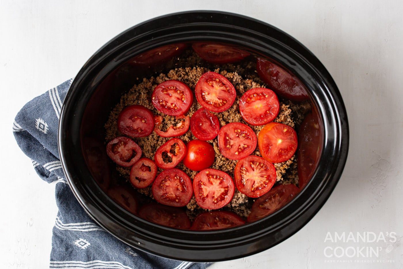 tomatoes on top of ground beef in crockpot