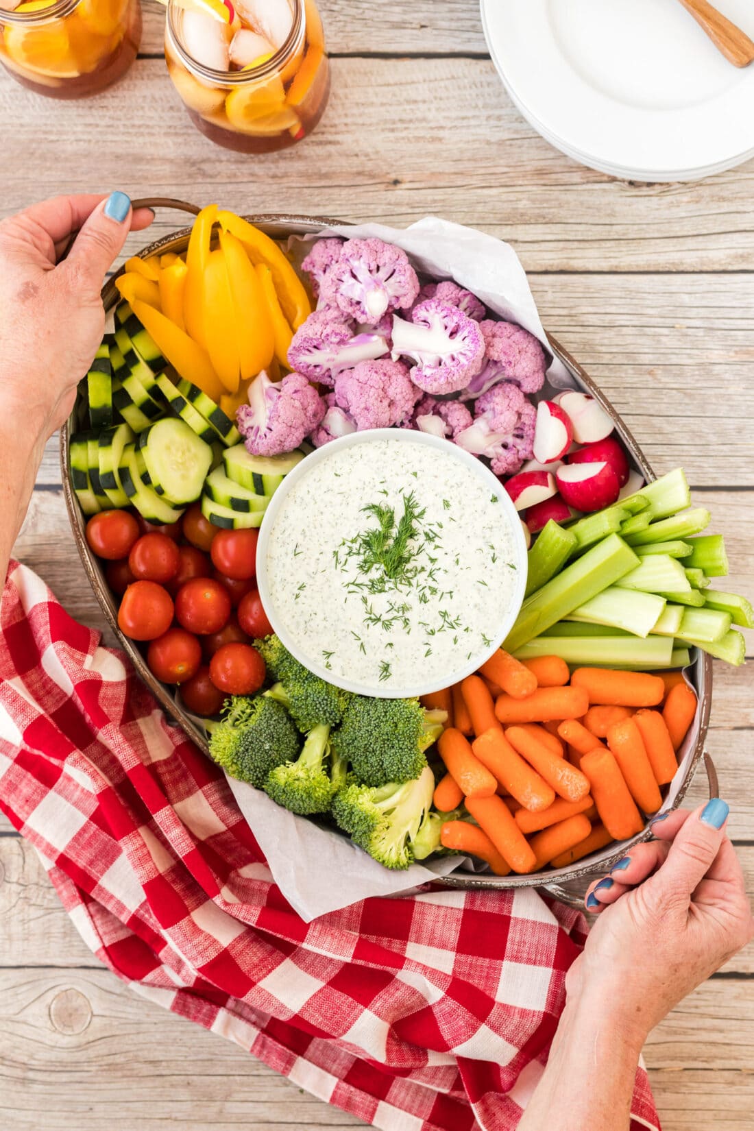 holding a tray of Dill Dip and veggies