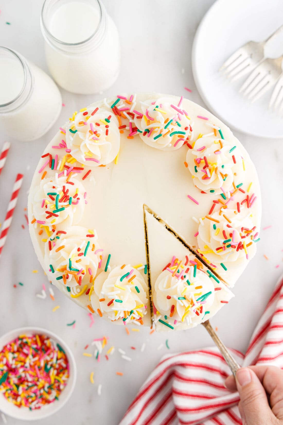 Overhead photo of Funfetti Cake with a slice being removed 