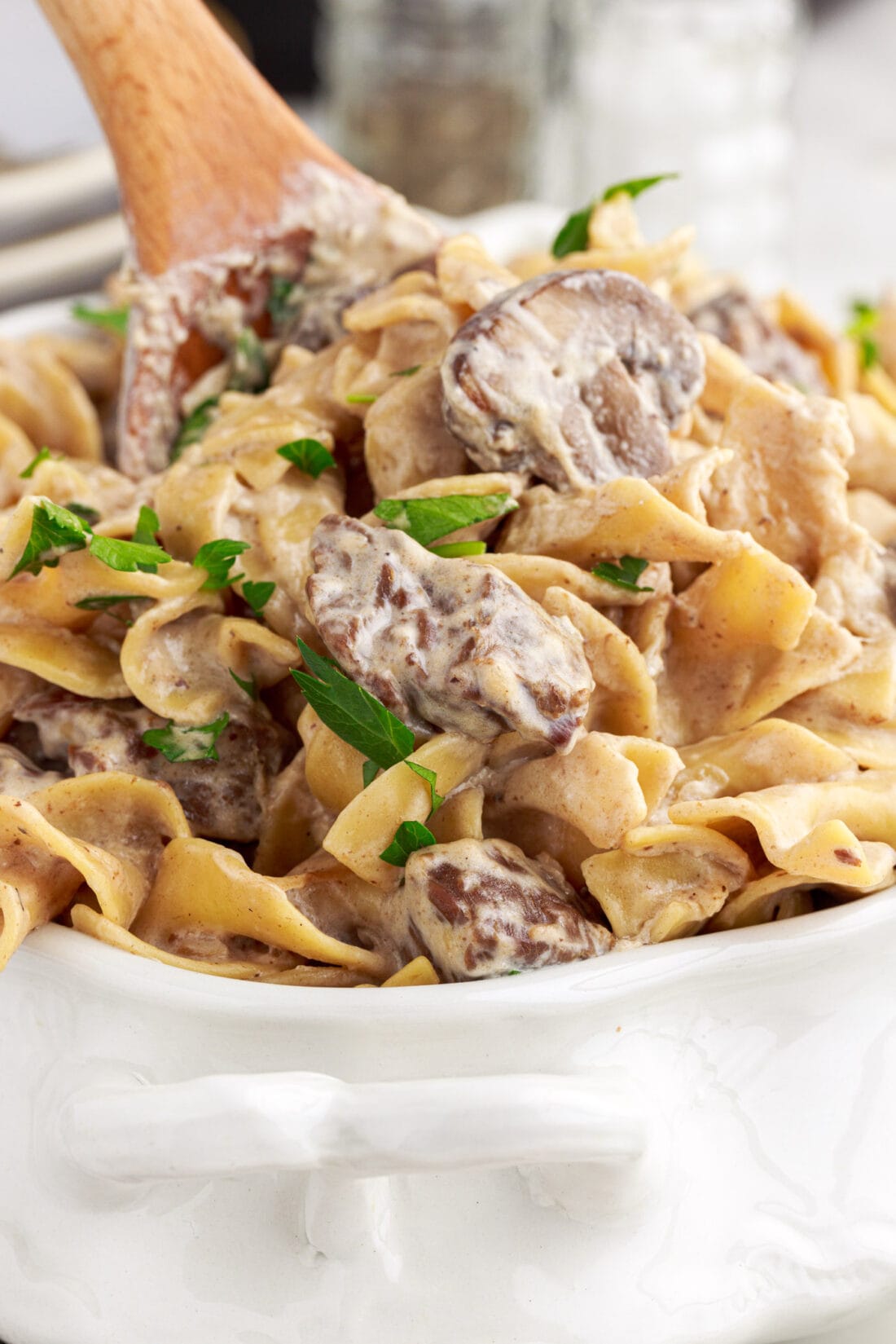wooden spoon lifting out Instant Pot Beef Stroganoff