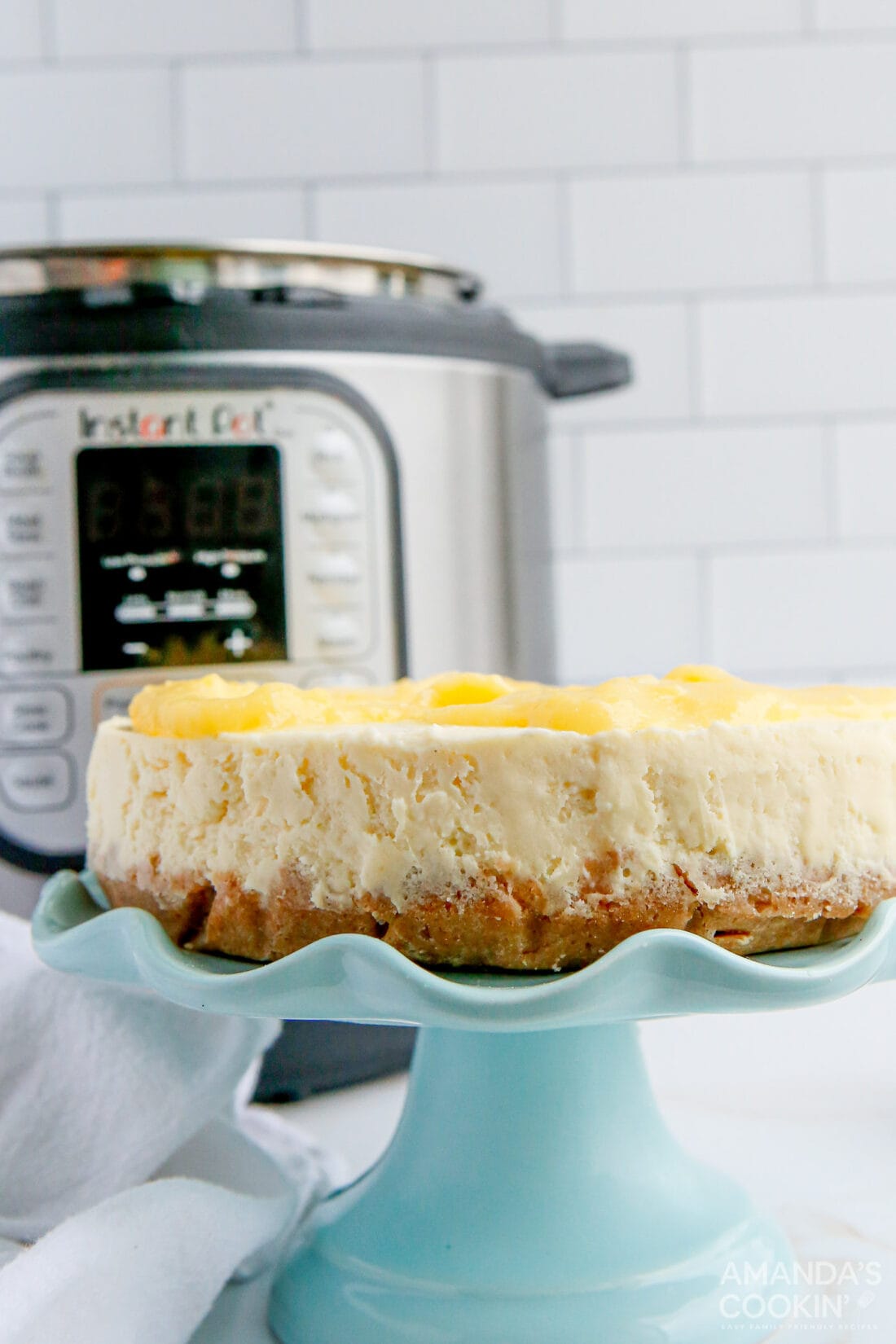 Instant Pot Lemon Curd Cheesecake on a cake plate