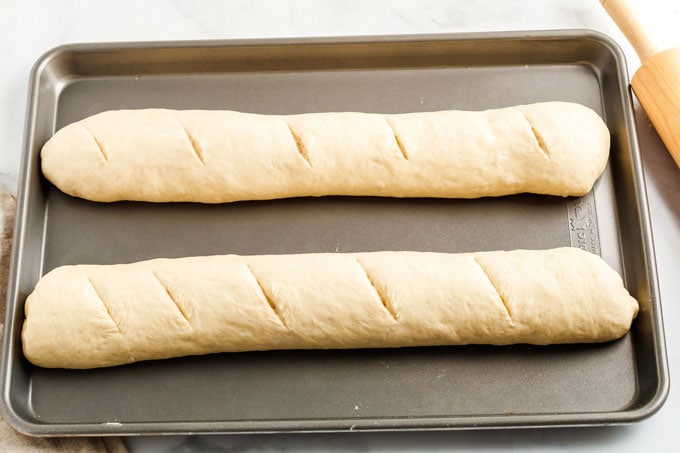 two loaves of bread dough on baking sheet