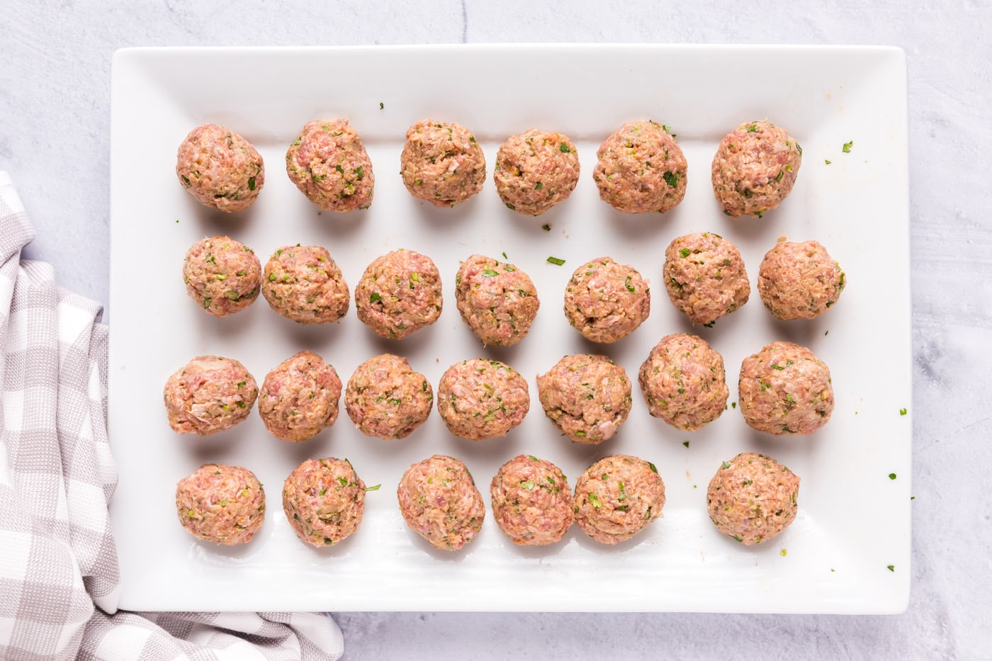rolled lamb meatballs on a tray