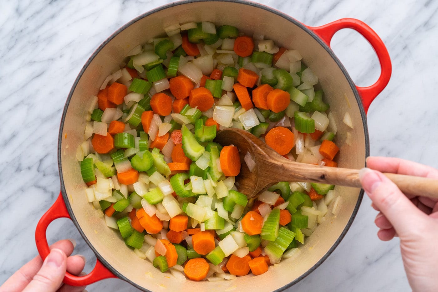 sauteeing onion, celery, and carrot with oil in a pot