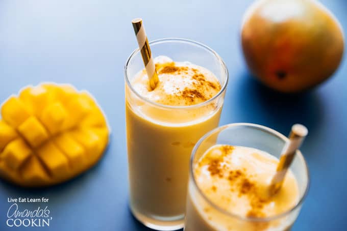 mango lassi smoothies in cup with straw