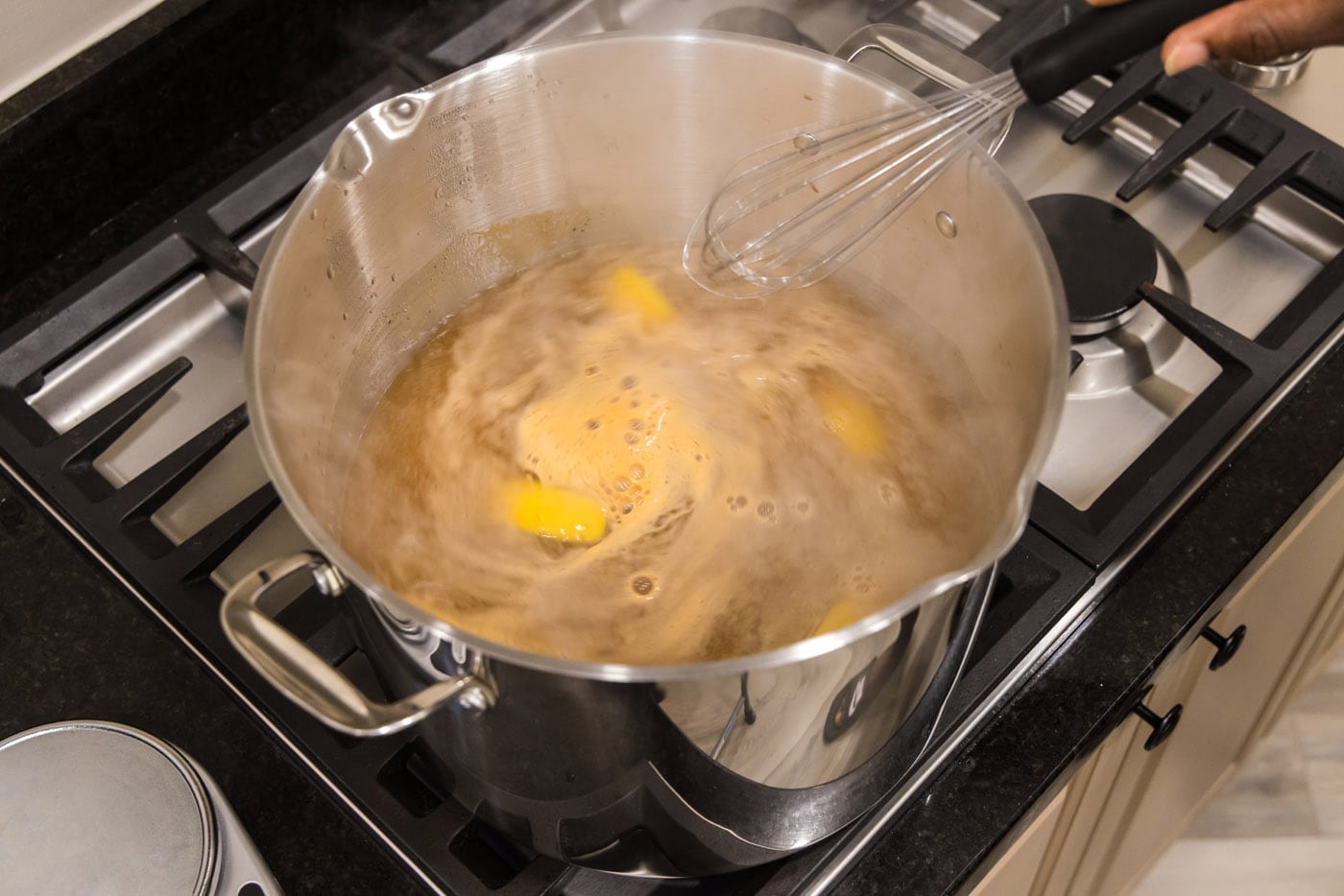 stirring lemon wedges, old bay, and garlic salt in a pot of water