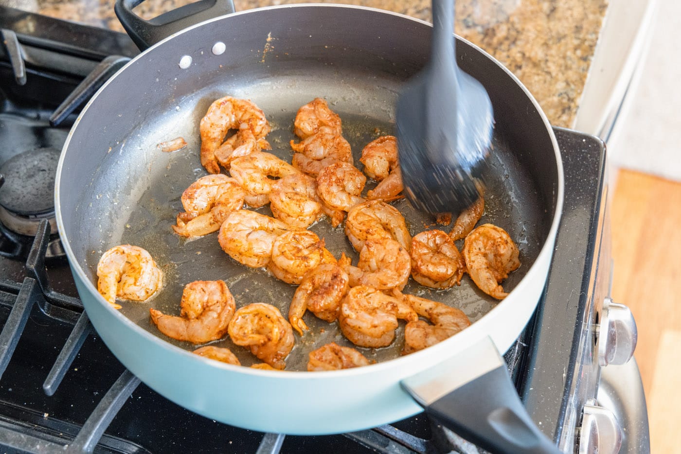 lightly cooking shrimp in skillet