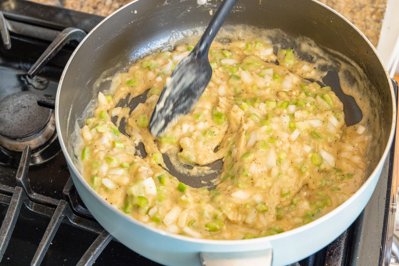 mixing gravy for shrimp etouffee in a skillet