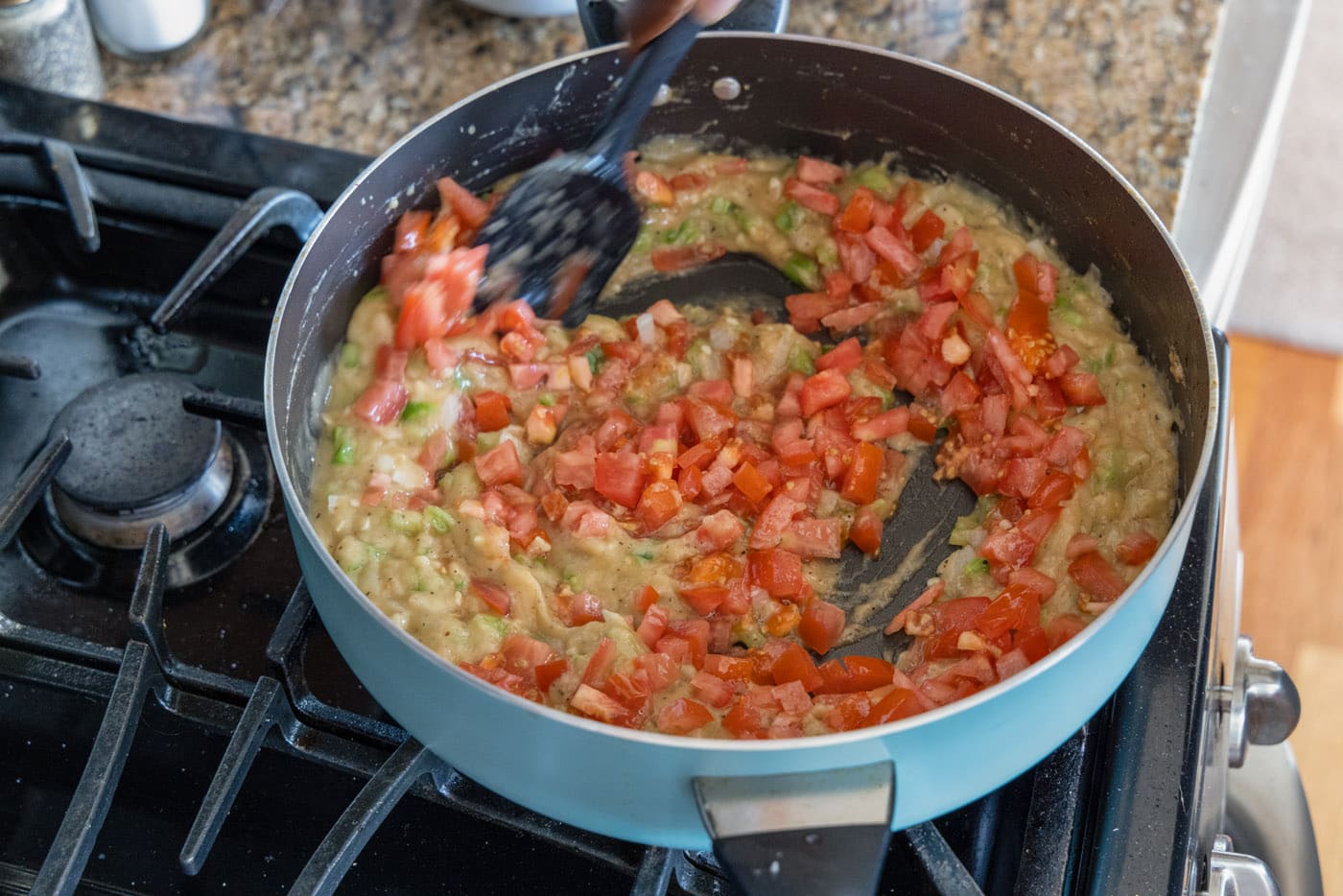 tomatoes added to skillet with etouffee gravy